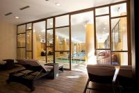 Centro benessere con piscina d'esperienza e area di riposo con sedie a sdraio - Hotel Bambara